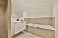  A bathroom with a bath tub, sink and toilet